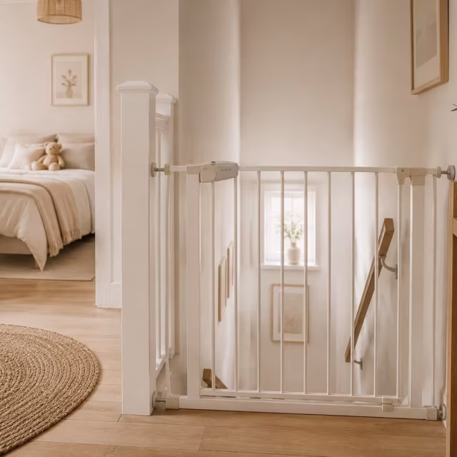 White stair gate fitted at the top of a staircase
