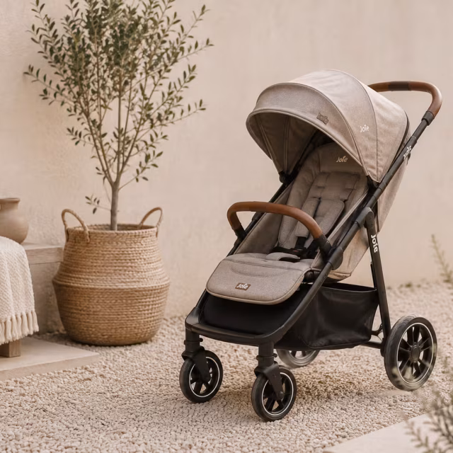 Beige stroller parked on a sunny terrace